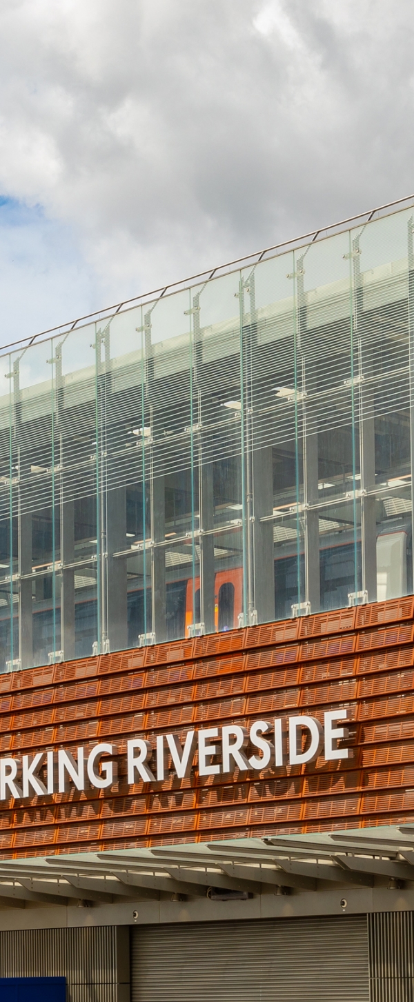 Barking Riverside station train pulls in against blue sky