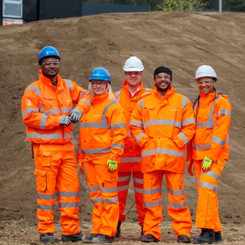 Generic group of people wearing orange PPE on construction site