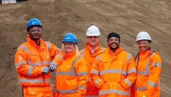Generic group of people wearing orange PPE on construction site
