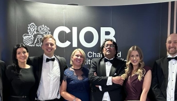 Group standing holding prize at an awards celebration