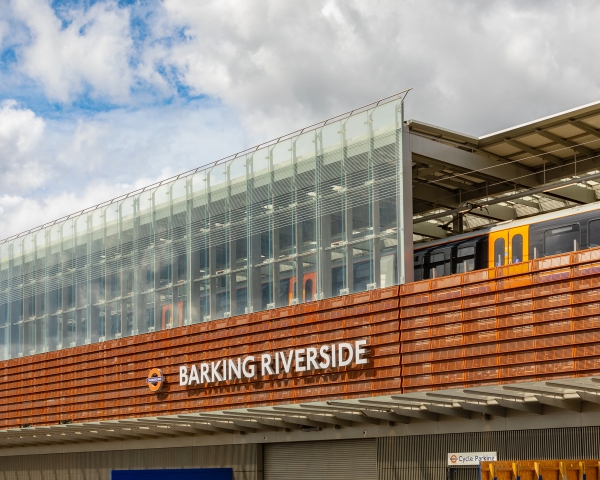 Barking Riverside station train pulls in against blue sky
